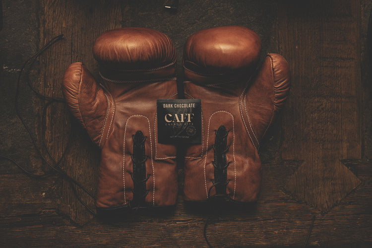 A Dark Chocolate CAFF bite with a pair of leather boxing gloves