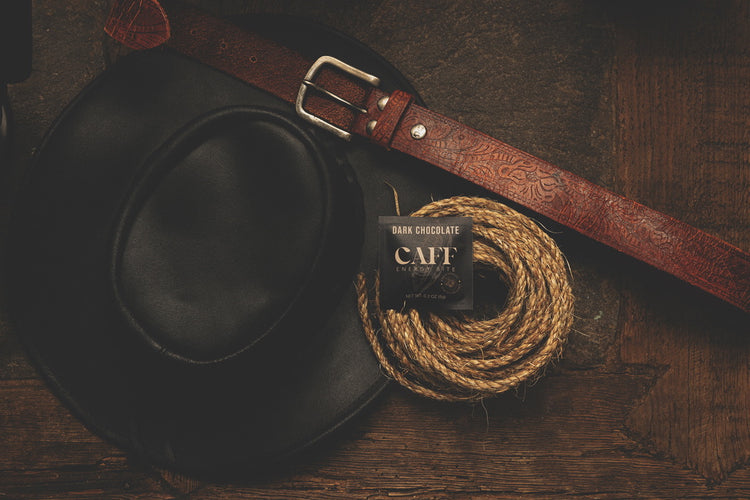 A Dark Chocolate CAFF bite with a cowboy hat, belt and coiled rope