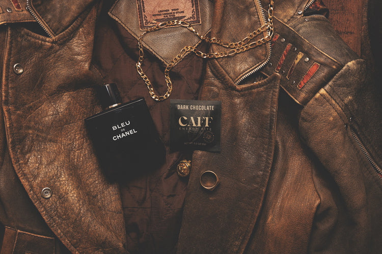 A Dark Chocolate CAFF bite with a leather jacket, cologne and gold chain