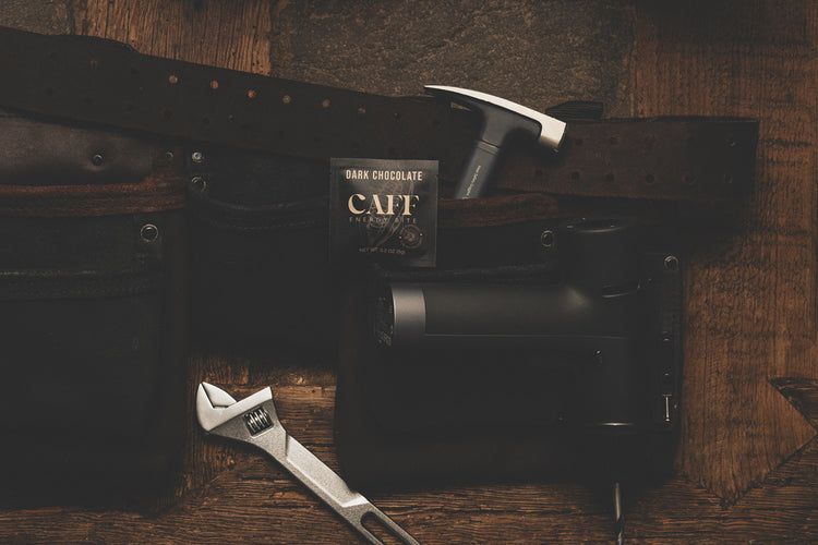 A Dark Chocolate CAFF bite with a tool belt, hammer and wrench